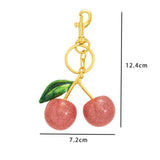 Petite Pink Cherry Keyring matched with a single green leaf, wrapping you in mild, quiet happiness each day In Australia - Darrahopens