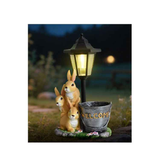 Solar Simulation Rabbit Ornament, charges by day and lights up automatically at night, three rabbits cluster around a street lamp with "WELCOME" bucket, warmly decorates courtyard and balcony, eco-friendly and healing./Resin flowerpot rabbit