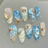 Blue seaside false nails, decorated false nails, seashell nail art, starfish nails, ocean-inspired nails, coastal nail designs, beach themed nails, Australian nail art