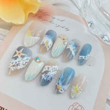 Blue seaside false nails, decorated false nails, seashell nail art, starfish nails, ocean-inspired nails, coastal nail designs, beach themed nails, Australian nail art