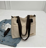 Stylish khaki canvas tote bag with detachable shoulder strap