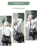 Stylish black tote backpack with heart embellishment - can be worn on one shoulder or as a backpack