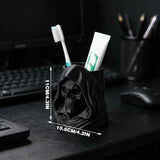 3D-printed hooded skull organizer, perfect for storing toothbrushes and toothpaste in your bathroom. Black.